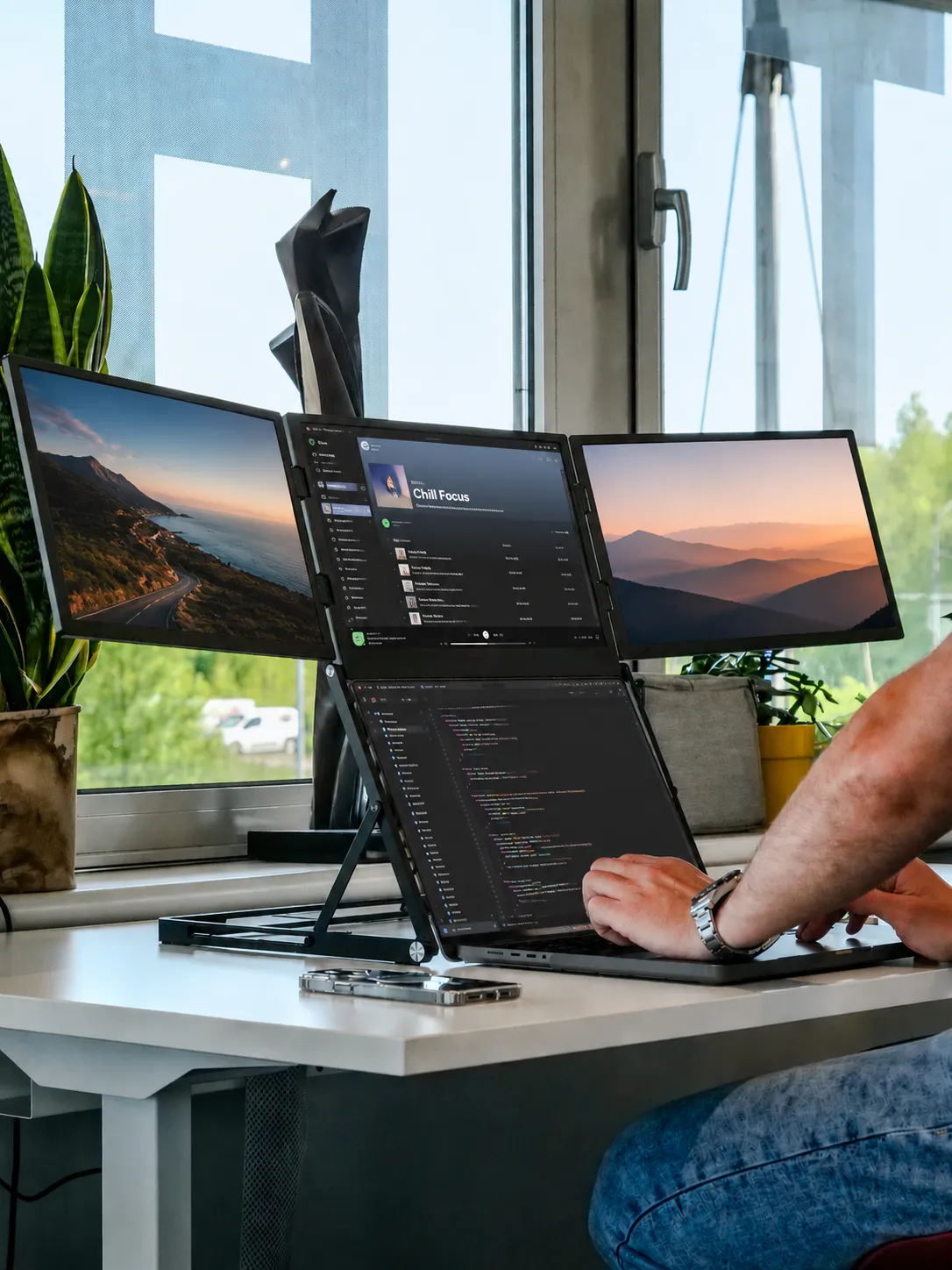 ROVE Horizon 3 four-screen workstation beside a window